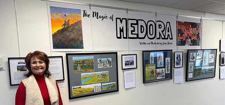 Artist Linda Donlin standing in front of her Medora-themed exhibit on the 18th floor of the ND Capitol