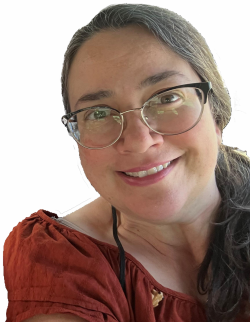 Head and shoulders of caucasian Robin Bosch wearing a wide-necked red, short-sleeve shirt, narrow-rimmed glasses, with a warm smile and her long brown hair in a side ponytail