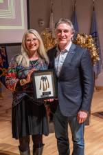 2023 ND Governor Award for the Arts recipient Pieper Fleck Bloomquist standing with Governor Doug Burgum