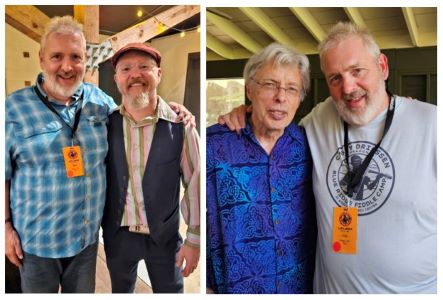 A man in a blue shirt, a man in a shirt and vest, a man with glasses in a blue shirt, a man in a gray t-shirt.