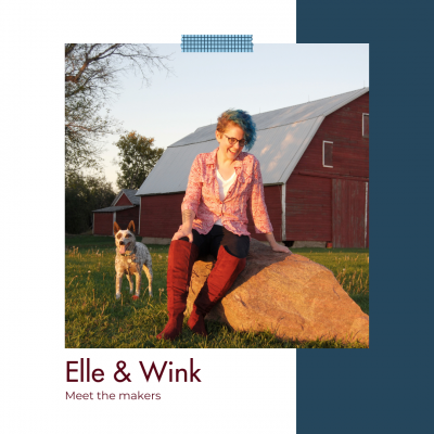 Artist Elle Billing and her spotted dog Winkie outside, in front of a red barn