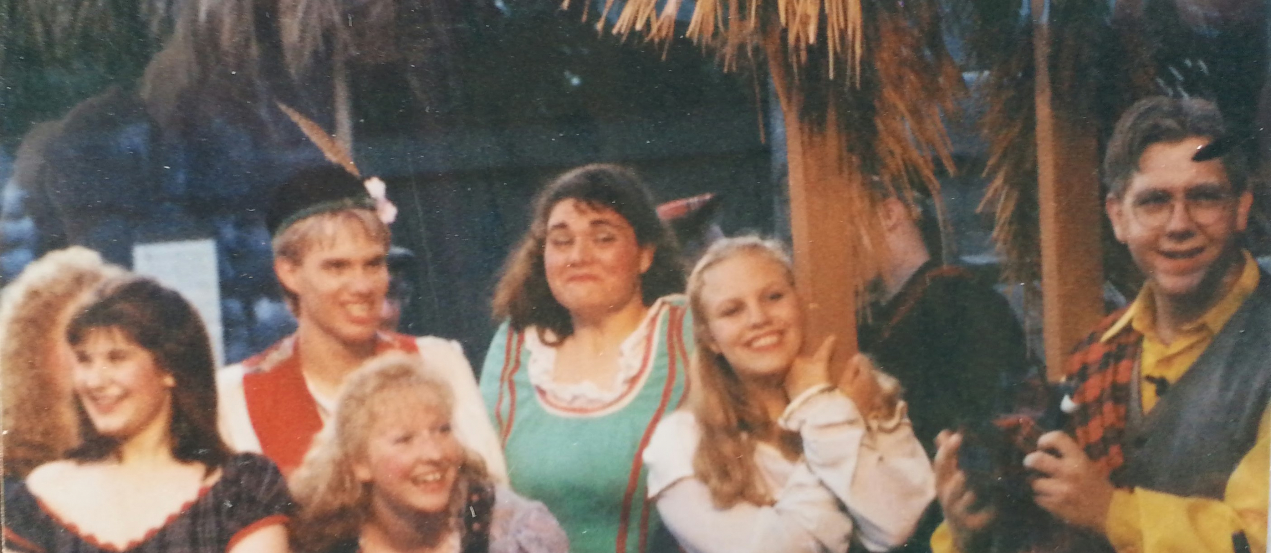 teenager Jason Grueneich in constume on stage, smiling and laughing with other actors, during a Sleepy Hollow Theatre production in the 1990s